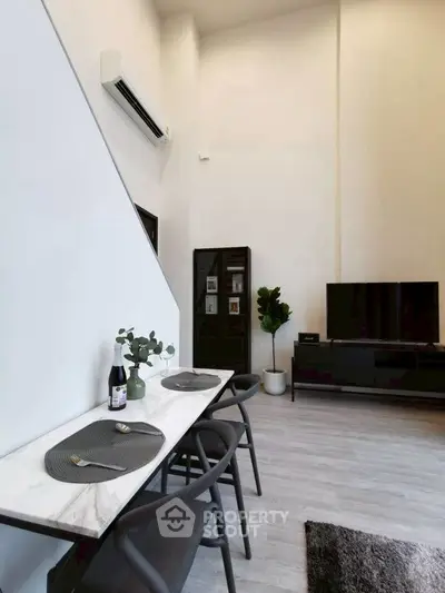Modern living room with high ceiling and sleek furniture design