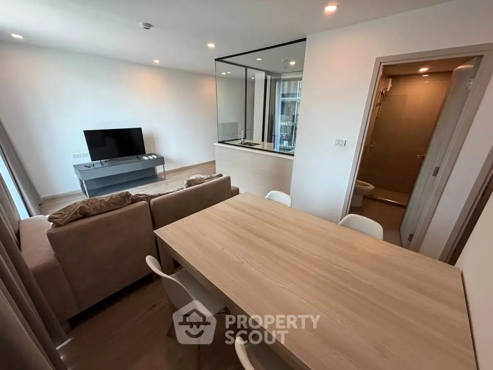 Modern open-plan living room with dining area and sleek kitchen design