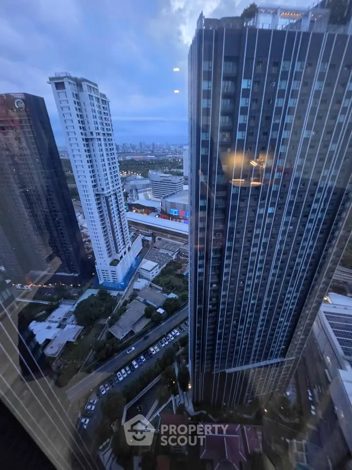 Stunning cityscape view from a high-rise building showcasing modern architecture and urban skyline.