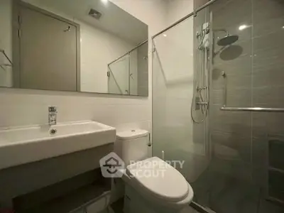 Modern bathroom with sleek fixtures and glass shower enclosure