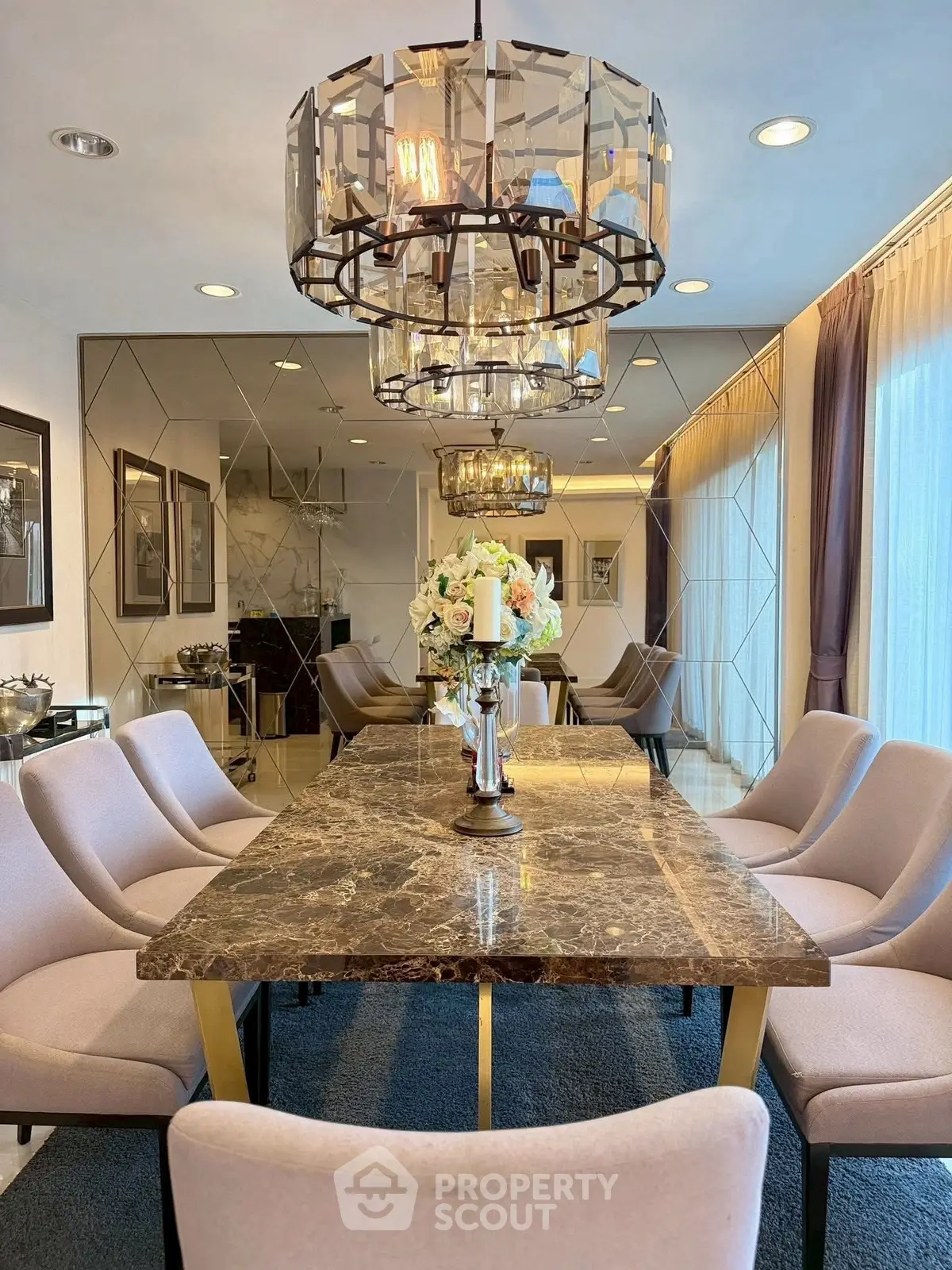 Luxurious dining room with elegant marble table and chic lighting fixtures.