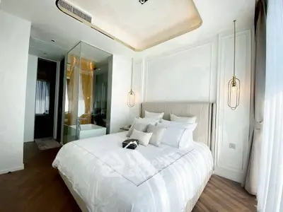 Luxurious bedroom with elegant decor and modern lighting in a stylish apartment.