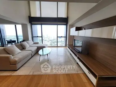 Luxurious living room with panoramic city view and modern furnishings.
