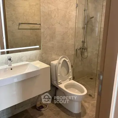 Modern bathroom with sleek fixtures and glass shower enclosure