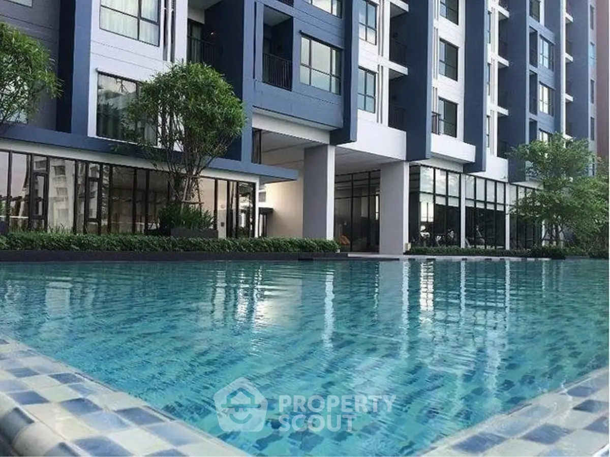 Modern condominium with luxurious pool and sleek architectural design.