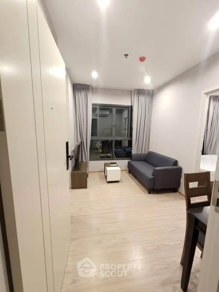 Modern living room with sleek furniture and city view, perfect for urban living.