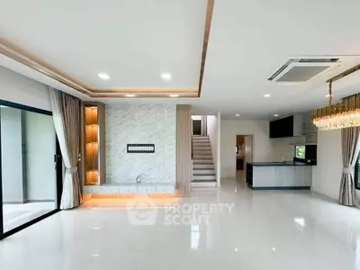 Spacious modern living room with elegant lighting and open kitchen layout