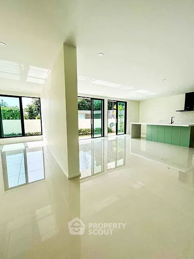 Spacious modern living room with open kitchen and large windows
