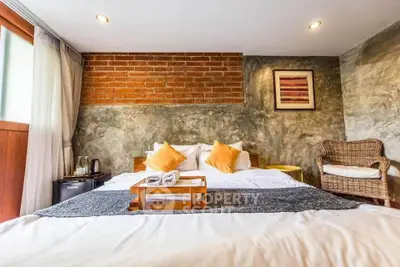 Charming bedroom with rustic brick wall and cozy decor, perfect for relaxation.