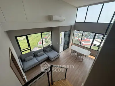 Spacious modern living room with large windows and city view