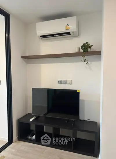 Modern living room with air conditioning and sleek TV setup