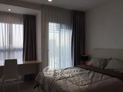 Modern bedroom with large windows and elegant curtains in a stylish apartment.