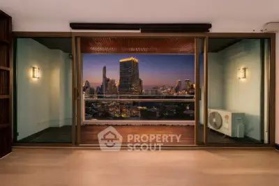 Stunning city view from modern apartment balcony with wooden flooring and glass doors.