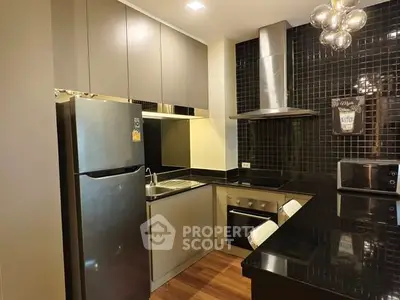 Modern kitchen with sleek cabinetry, stainless steel appliances, and stylish lighting.