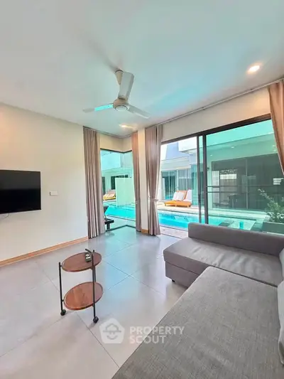Modern living room with pool view and sleek furniture in luxury home