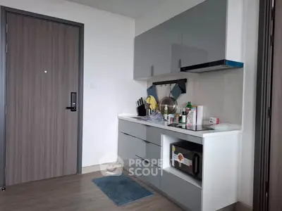 Modern kitchen with sleek cabinetry and microwave in stylish apartment