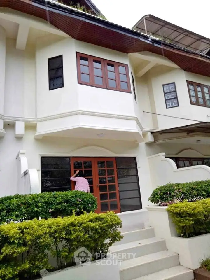 Charming townhouse exterior with lush greenery and modern design.