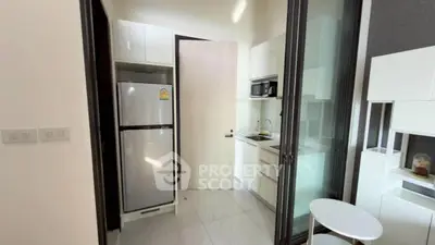 Modern compact kitchen with sleek appliances and minimalist design