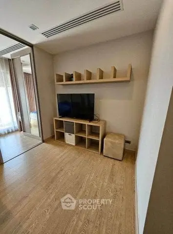 Modern living room with wooden flooring and built-in TV unit