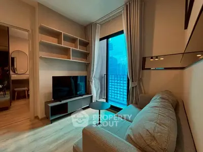 Modern living room with large window and city view, featuring a cozy sofa and sleek entertainment unit.