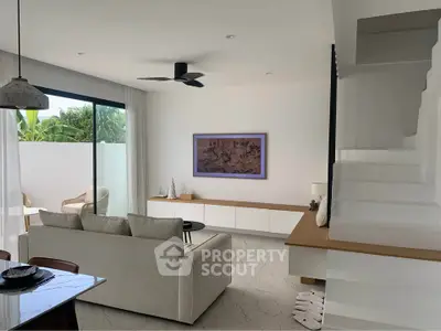 Modern living room with sleek design, featuring a cozy sofa, stylish ceiling fan, and large sliding glass doors opening to a patio.