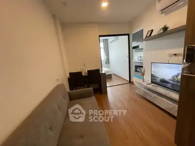 Modern living room with cozy sofa and flat-screen TV in stylish apartment.