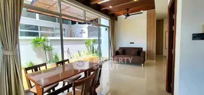 Modern living room with large windows and elegant dining area