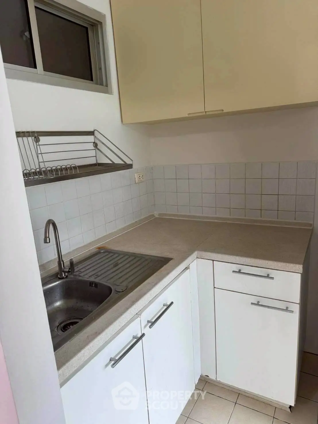 Compact kitchen with modern sink and ample storage in a cozy apartment