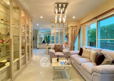 Luxurious living room with elegant decor and large windows offering natural light