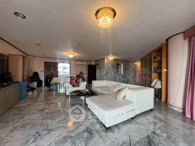 Spacious living room with marble flooring and elegant lighting