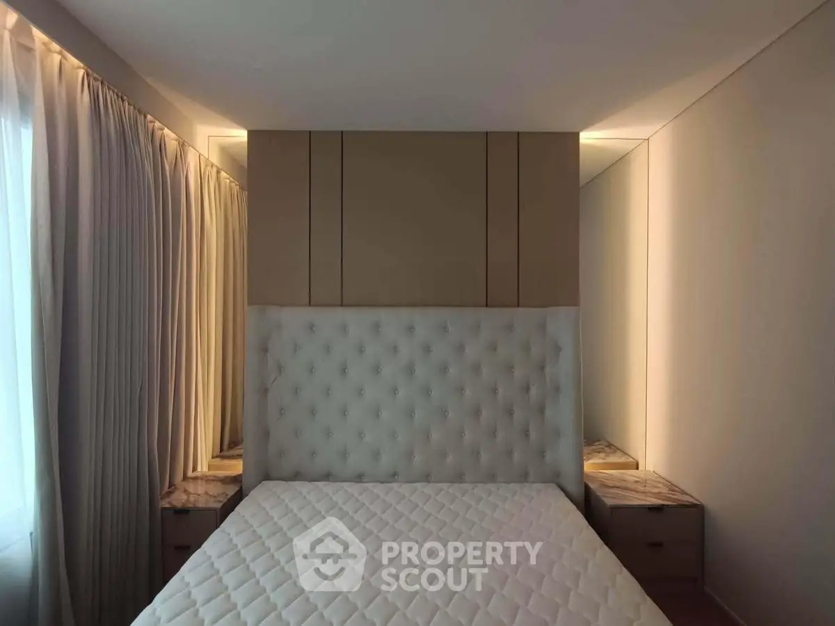 Luxurious bedroom with elegant tufted headboard and soft lighting