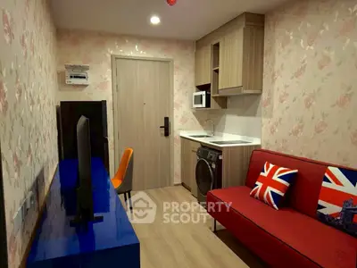 Cozy living room with modern decor and vibrant accents in a compact apartment.