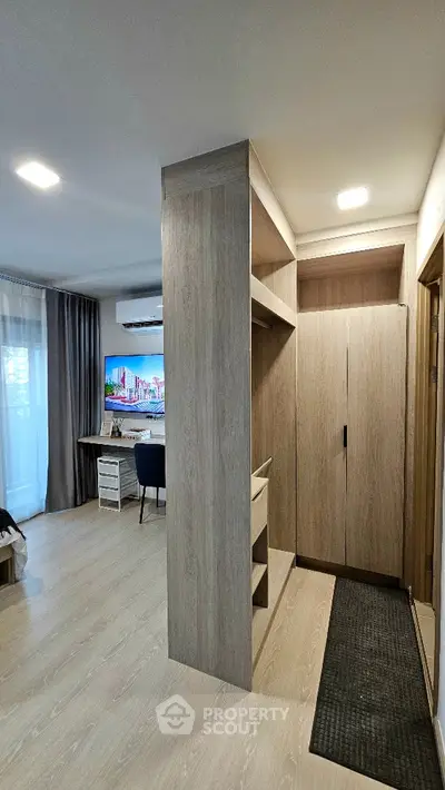 Modern apartment interior with stylish wooden cabinetry and cozy living area