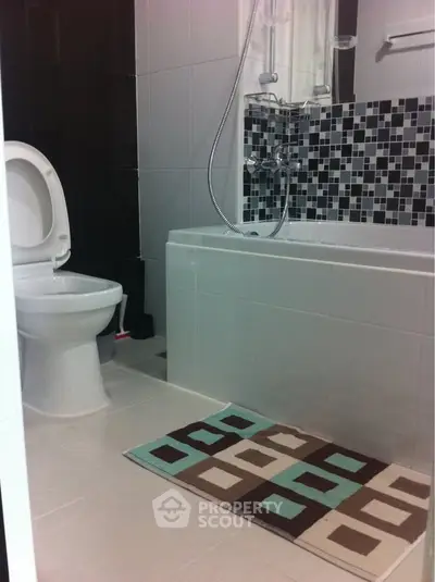 Modern bathroom with stylish tile design and bathtub, perfect for relaxation.