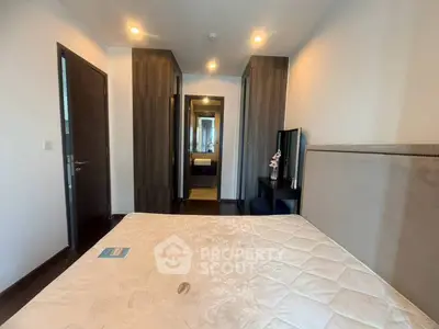 Modern bedroom with elegant decor and ample storage space in a stylish apartment.