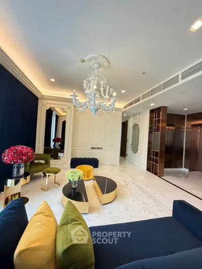 Luxurious living room with elegant chandelier and plush seating in a high-end apartment.