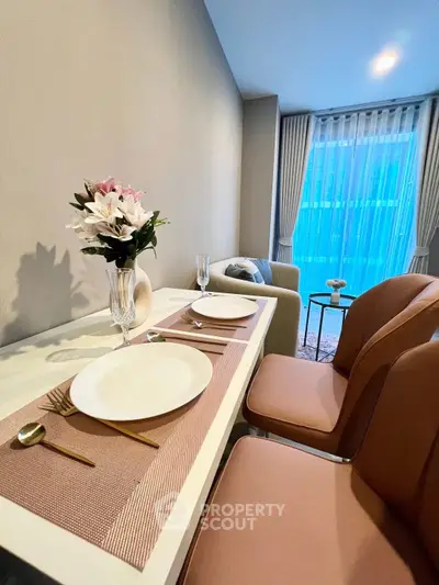Stylish dining area with elegant table setting and cozy seating in modern apartment.