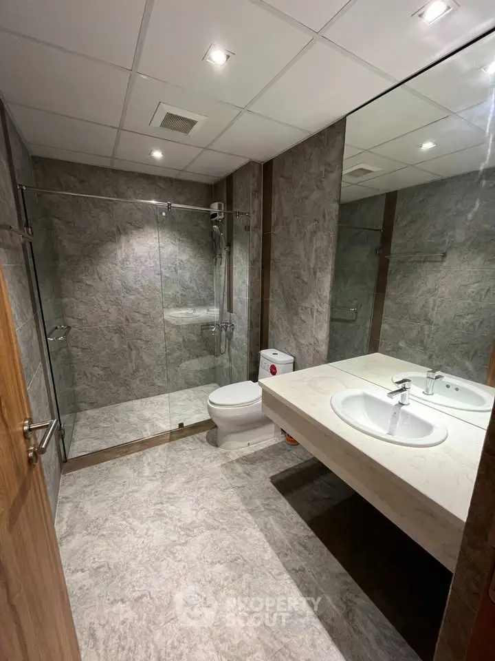 Modern bathroom with glass shower and sleek fixtures