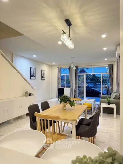 Spacious modern living room with dining area and large windows for natural light.