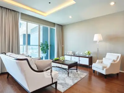 Elegant living room with modern furniture and large windows offering a stunning view.