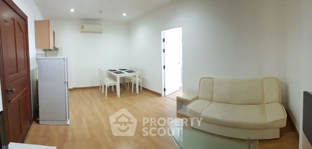 Spacious living room with modern furniture and dining area, perfect for family gatherings.