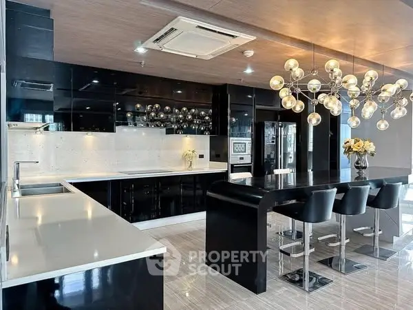 Luxurious modern kitchen with sleek black cabinetry and elegant lighting