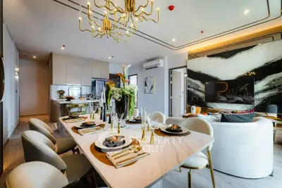 Luxurious modern dining and living area with elegant decor and open layout.