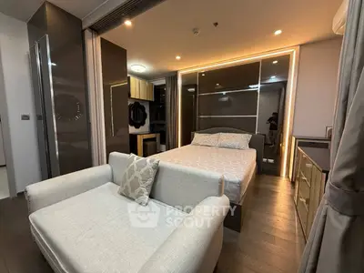 Modern bedroom with stylish decor and cozy seating area