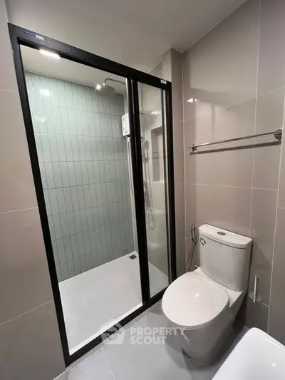 Modern bathroom with sleek shower enclosure and contemporary fixtures.