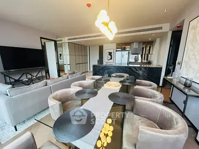 Luxurious open-plan living and dining area with modern kitchen and elegant decor.