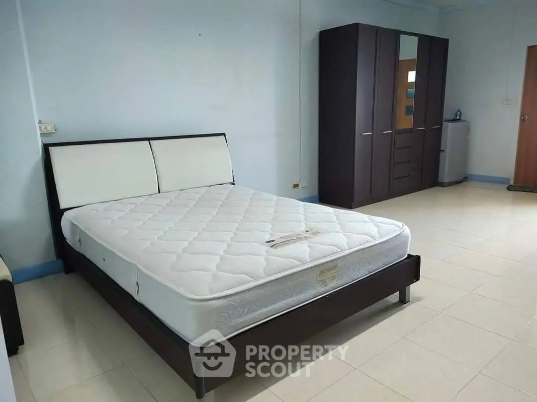 Spacious bedroom with modern furniture and ample storage space