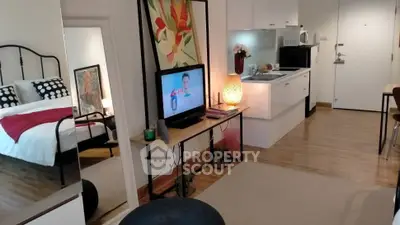 Modern studio apartment with open kitchen and cozy living area, featuring stylish decor and a comfortable bed.