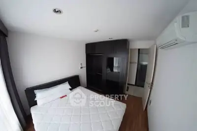 Modern bedroom with sleek design and ample storage in a stylish apartment.