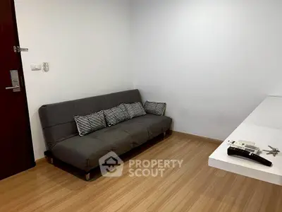 Cozy living room with modern gray sofa and wooden flooring